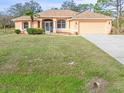 Single-story home with a large front yard and attached garage at 5465 Trumpet St, North Port, FL 34291