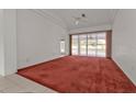 Living room with red carpet, sliding doors, and pool view at 87 Torrington St, Port Charlotte, FL 33954