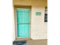 Light teal front door with glass panels and a welcoming doormat at 175 Kings Hwy # Bldg 3 314, Punta Gorda, FL 33983