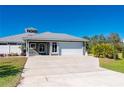 Single story home with metal roof, attached garage, and large yard at 2329 Pinellas Dr, Punta Gorda, FL 33983