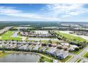 Aerial view of a golf course community with lakes and well-maintained homes at 25187 Keygrass Ct, Punta Gorda, FL 33955