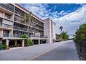 Condo building exterior showcasing parking and landscaping at 25188 Marion Ave # D205, Punta Gorda, FL 33950