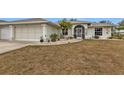 Front view of a single story home with a two-car garage at 2577 Mauritania Rd, Punta Gorda, FL 33983