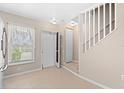 View of entryway with white door and staircase at 26346 Rampart Blvd # 904, Punta Gorda, FL 33983