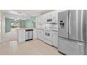 Bright kitchen with stainless steel appliances and white cabinets at 26346 Rampart Blvd # 904, Punta Gorda, FL 33983