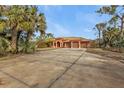 Large house with a three-car garage and a long driveway at 3000 Narcissus Ter, North Port, FL 34286
