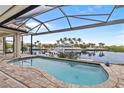 Relaxing pool area with covered patio overlooking the canal at 3513 Terin Ct, Punta Gorda, FL 33950