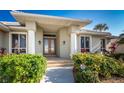 Front entrance with double doors and columned portico at 3932 Madrid Ct, Punta Gorda, FL 33950