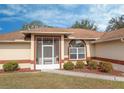 House entrance with screened porch and well-manicured landscaping at 4046 Lubec Ave, North Port, FL 34287