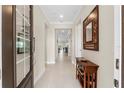 Bright and spacious entryway with a wooden console table and mirror at 42115 Edgewater Dr, Punta Gorda, FL 33982