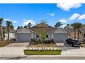 Two-story home with gray garage doors and nicely landscaped yards at 43620 Sparrow Dr, Punta Gorda, FL 33982
