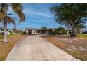 Front view of single story home with circular driveway at 450 Capri Isles Ct, Punta Gorda, FL 33950