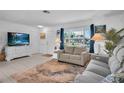 Living room with gray couches, white dresser, and coastal decor at 745 Kellstadt Nw St, Port Charlotte, FL 33952