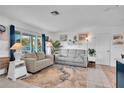 Living room with gray couches, coastal decor, and views of the front yard at 745 Kellstadt Nw St, Port Charlotte, FL 33952