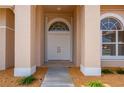 Double front doors with arched window detail and sidelights at 8326 Creekview Ln, Englewood, FL 34224
