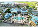 Aerial view of upscale community with pool, landscaping, and water access at 87 Vivante Blvd # 403, Punta Gorda, FL 33950