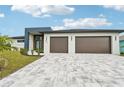 Contemporary home with a two-car garage and stone driveway at 9516 President Cir, Port Charlotte, FL 33981