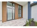 Modern front entrance with wood paneling and glass double doors at 9516 President Cir, Port Charlotte, FL 33981