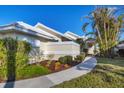 Inviting exterior with landscaped walkway leading to the entrance at 10 Windward Ct, Placida, FL 33946