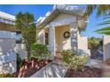 Welcoming front entrance with lush landscaping and a charming wreath at 10 Windward Ct, Placida, FL 33946