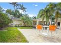 Backyard patio with orange chairs and a small table at 110 Chasteen St, Punta Gorda, FL 33950