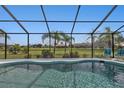 Relaxing pool area with a screened enclosure and backyard view at 1188 Paraclete Rd, Punta Gorda, FL 33983