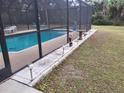 Screened-in pool area with solar lights and patio at 14057 Maxwell Ave, Port Charlotte, FL 33953