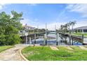 Private dock and canal access with lush tropical landscaping at 1511 Casey Key Dr, Punta Gorda, FL 33950