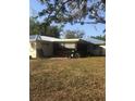 Back of the house with screened porch and yard at 15570 Rasmussen Rd, Punta Gorda, FL 33982