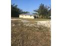 Back of house showing additional building and yard at 15570 Rasmussen Rd, Punta Gorda, FL 33982