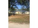 Single story home with metal roof, and a fenced yard at 15570 Rasmussen Rd, Punta Gorda, FL 33982