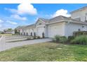 Row of attached garages with paved pathway and landscaping at 15960 Grassland Ln # 2722, Punta Gorda, FL 33982