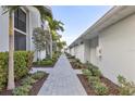 Landscaped walkway between building and garage at 15960 Grassland Ln # 2722, Punta Gorda, FL 33982