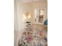 Bright entryway with floral rug, console table, and mirror at 1601 Park Beach Cir # 136/18, Punta Gorda, FL 33950