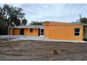 Rear view of house showing patio and landscaping at 201 Winson Ave, Englewood, FL 34223