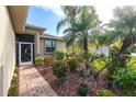 Landscaped walkway leading to the front door of the house at 24667 Rio Villa Lakes Cir, Punta Gorda, FL 33950