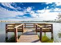 Wooden dock with seating overlooking a lake at 25225 Rampart Blvd # 1701, Punta Gorda, FL 33983