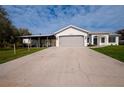 House exterior featuring a gray roof and attached garage at 29350 Goodhue St, Punta Gorda, FL 33982