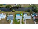 Bird's eye view of single-story home with pool and canal view at 3448 Middletown St, Port Charlotte, FL 33952