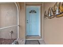 Light blue front door and decorative wall art at 420 Chamber Nw St, Port Charlotte, FL 33948