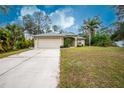 House with a driveway and manicured lawn at 4522 Mckay St, North Port, FL 34286