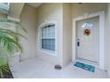 Front door entrance with a wreath and a welcome mat at 4522 Mckay St, North Port, FL 34286