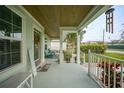 Inviting front porch with seating area and wood ceiling at 526 Allen St, Punta Gorda, FL 33950