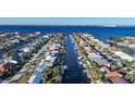 Aerial view of houses along a canal with boats and lush landscaping at 66 Ocean Dr, Punta Gorda, FL 33950