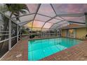 Relaxing pool area with screened enclosure and water view at 820 Via Tunis, Punta Gorda, FL 33950