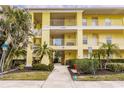 Condo building exterior showing entrance and landscaping at 2060 Willow Hammock Cir # 302, Punta Gorda, FL 33983