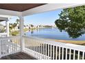 Scenic view of a tranquil lake from a balcony with white railings and wood deck floor at 108 Pompano Se Dr # D, St Petersburg, FL 33705