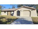 Single-story house with a large driveway and mature trees at 1174 Victoria Ave, Port Charlotte, FL 33948