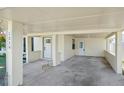 Covered carport with concrete flooring and access to the home at 1219 Ansin St, Punta Gorda, FL 33950