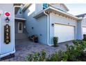 Townhome entry with paver driveway and a bench at 14138 Poppy Field Loop # 4122, Punta Gorda, FL 33955